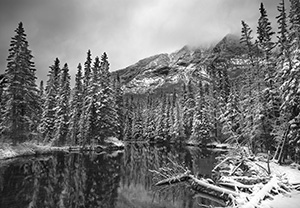 During a light late spring snowfall the water is still and the surroundings quiet. - 777 Photograph