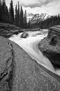 Water runs fast through Mistaya Canyon in the spring during the snow melt. - 777 Photograph