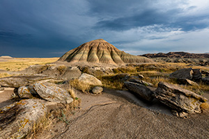 A scenic landscape photograph of Toadstool Geologic Park in western Nebraska under dark skies. - Nebraska Photograph