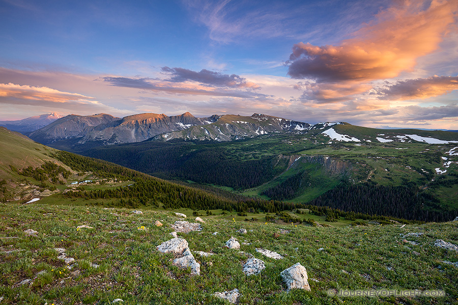 Clouds gather above the tops of the mountains in Rocky Mountain National Park as the last warm glow of sunset grazes the peaks. - Colorado Photography