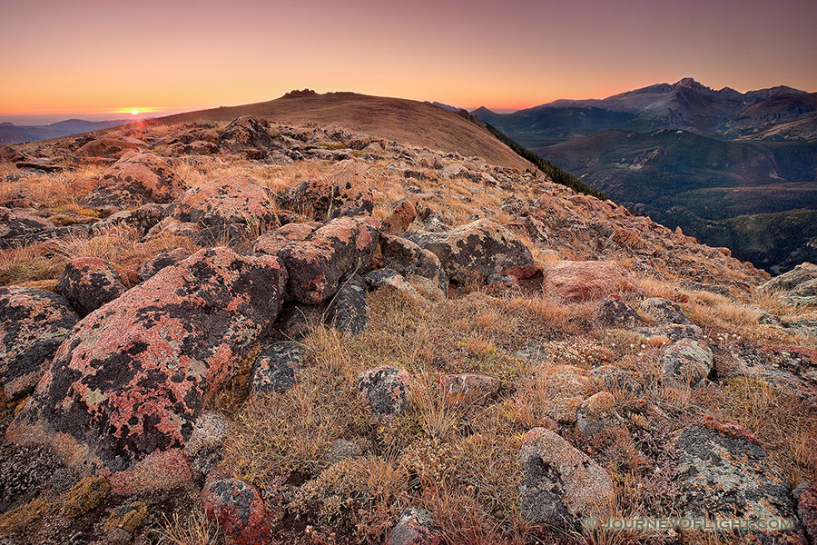 On this day, as many days through time, the exposed rocks on the tundra area of Rocky Mountain National Park bear witness to the rising sun and its illumination of Longs Peak. - Colorado Photography