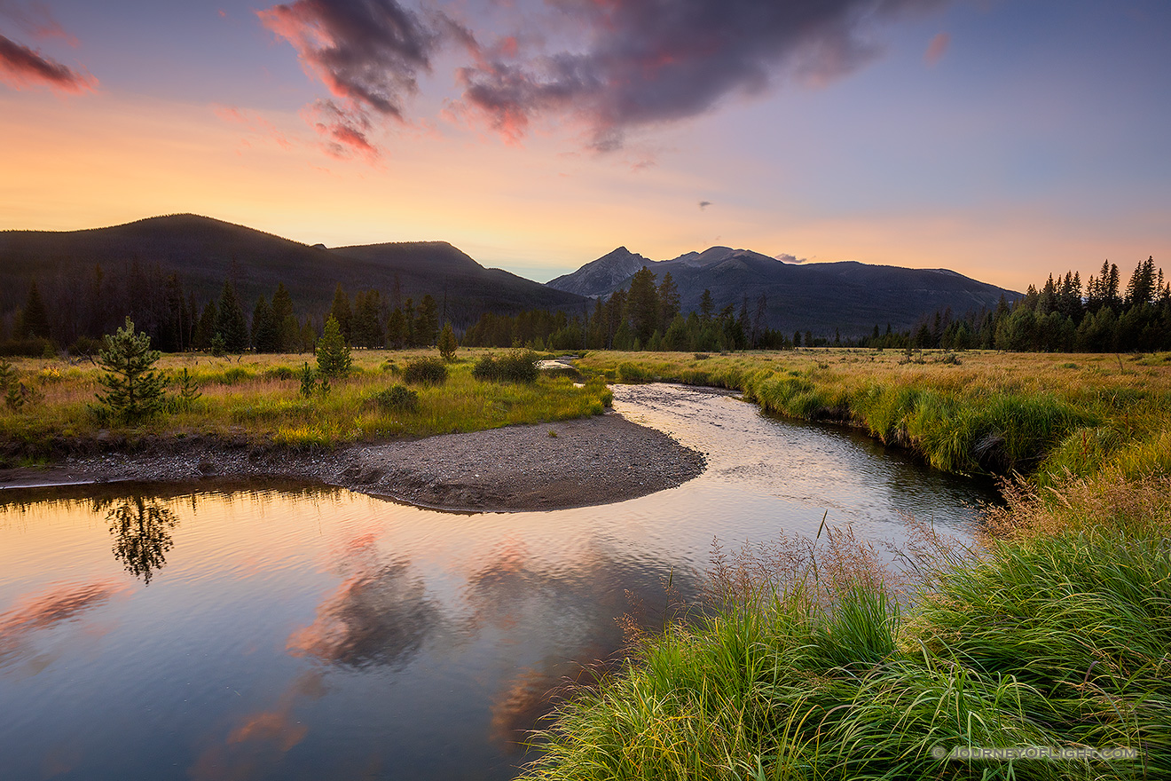 The sun sets behind the Never Summer Range as the Kawunechee River flows through the west side of Rocky Mountain National Park in Colorado. - Colorado Picture