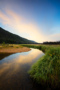 On the west side of Rocky Mountain National Park, the North Inlet stream snakes through a meadow and reflects a beautiful autumn sunrise. - Colorado Landscape Photograph