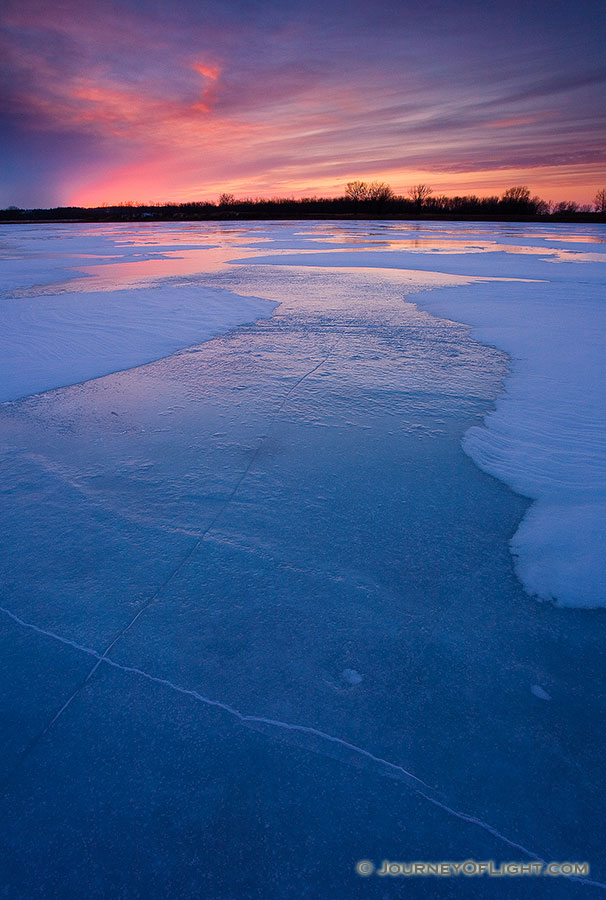 The former oxbow of the Missouri River, the oxbow at DeSoto National Wildlife Refuge is completely frozen on a frigid January evening. - DeSoto Photography