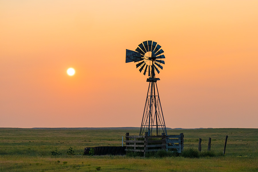 Scenic landscape photograph of a windmill and sun at Oglala National Grasslands. - Nebraska Photography