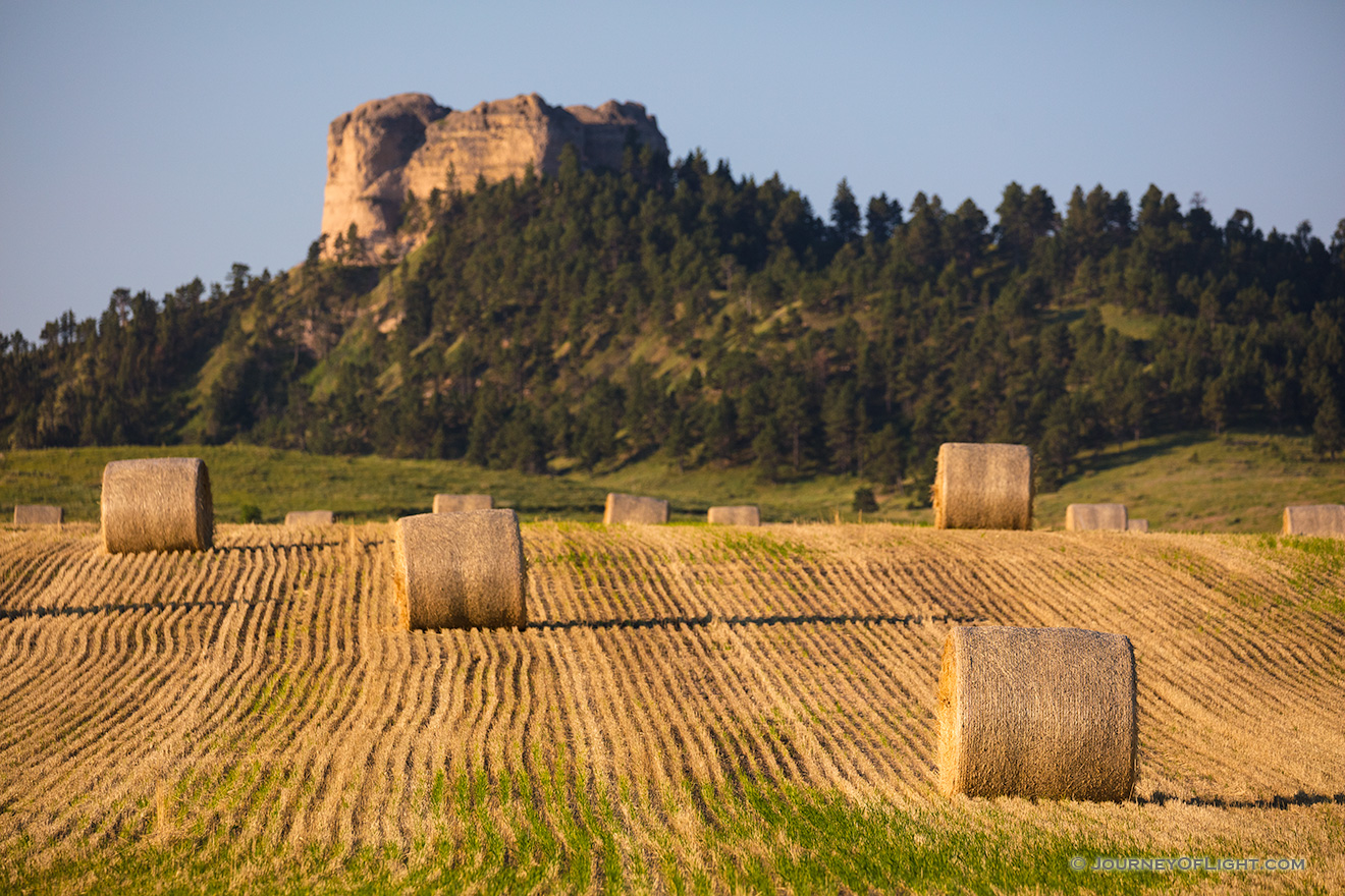 A Nebraska photograph of Hay Bales in the morning under Lovers Leap at Fort Robinson State Park. - Nebraska Picture