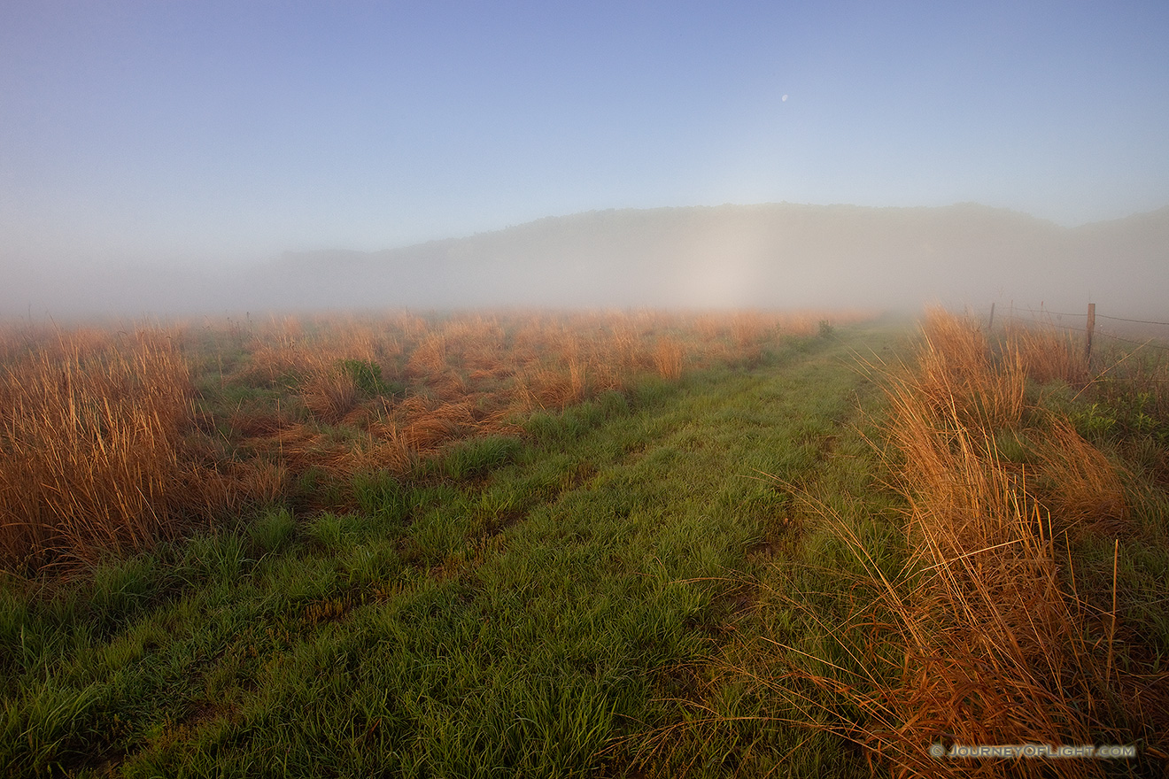 In the early morning at Ponca State Park, the setting moon descends into the fog rising from the prairie. - Ponca SP Picture