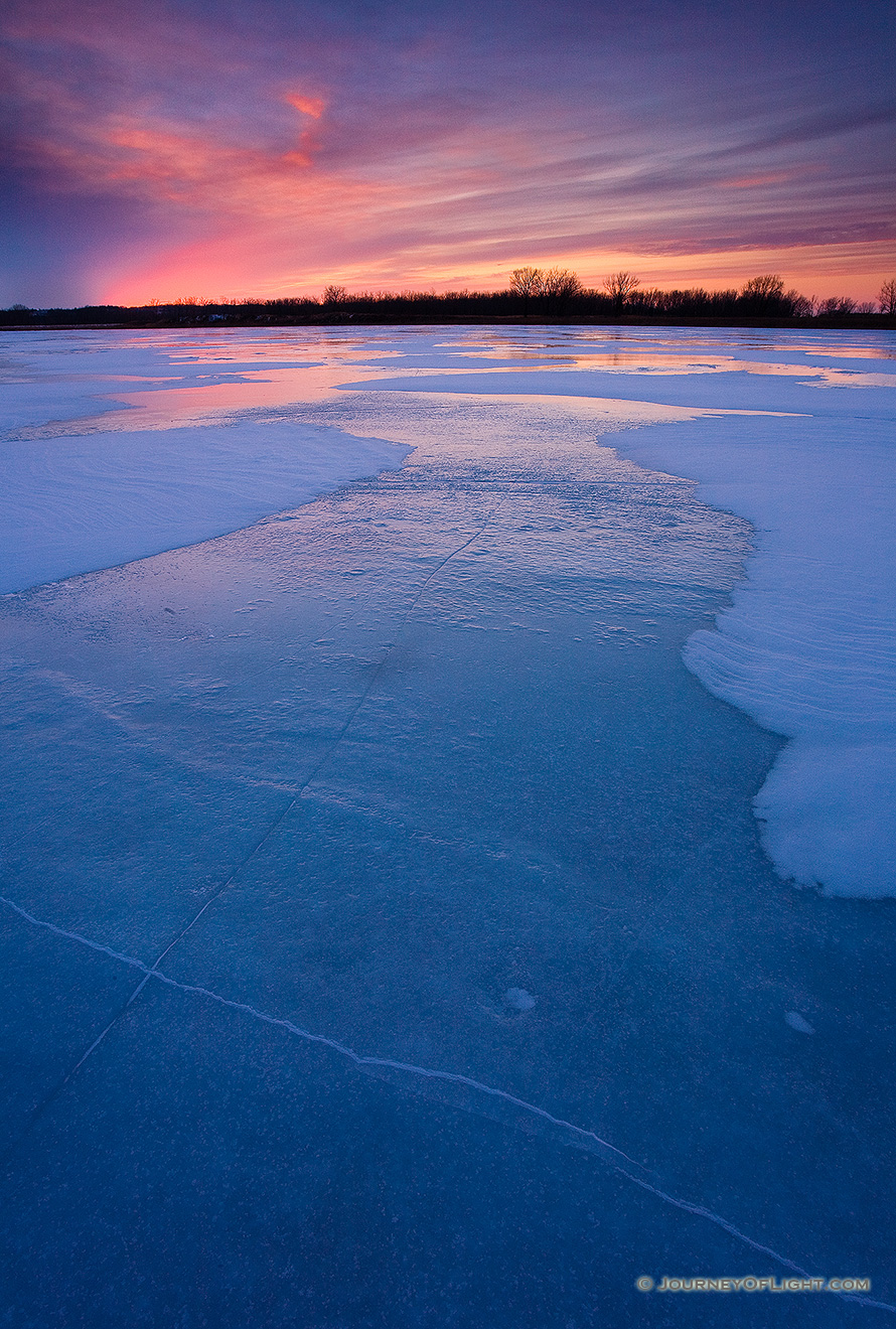 The former oxbow of the Missouri River, the oxbow at DeSoto National Wildlife Refuge is completely frozen on a frigid January evening. - DeSoto Picture