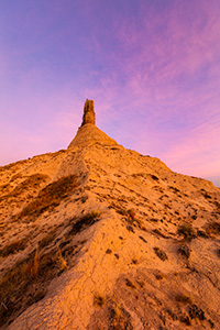 A scenic vertical landscape Nebraska photograph of a sunset and Chimney Rock in western Nebraska. - Nebraska Photograph