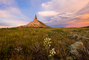 A scenic landscape photograph of the sunset and Chimney Rock National Historic Site. - Nebraska Photograph
