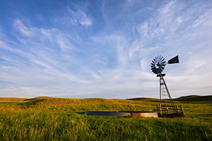 Late afternoon sun illuminates an abandoned windmill deep in the Sandhills of Nebraska. - Nebraska Sandhills Photograph