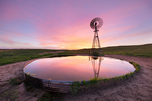 A photograph of a windmill in the Nebraska Sandhills during a summer sunset. - Nebraska Sandhills Photograph