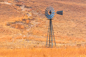 A scenic landscape photograph of a windmill in the sandhills of Nebraska. - Nebraska Photograph