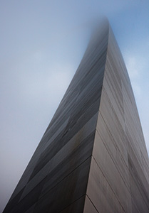 The Gateway Arch curves through the sky and into the fog.  - Missouri Photograph