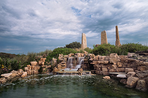 Ponca State Park in northeastern Nebraska features the 'Towers of Time' monument, created by Jay Tschetter and it represents various eras in Earth's past:
				<p>The 25-foot tower on the left depicts the late Cretaceous Period (65 million to 99 million years ago) when Nebraska was under water. This was the age of the dinosaurs and displays prehistoric sea and land creatures.
				<p>The 27-foot center tower features species from the Pleistocene Period (1.8 million to 10,000 years ago). This was during the Ice Age when woolly mammoths, saber-toothed cats and giant sloths roamed the Earth.
				<p>The 25-foot tower on the right features a collection of modern animals, everything from blue herons to buffalo that inhabit the Missouri River region.
				<p>The square fountain includes images of indigenous people from the Folsom culture, Paleolithic period, Earth Mound Builders and recent Natives who occupied the region in the 1800s.
			 - Nebraska Photograph