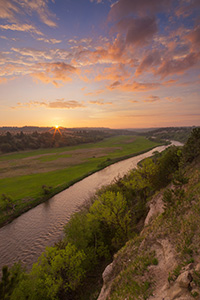 The Niobrara is one of the most popular rivers for canoeing and tubing in the United States.  On a beautiful spring sunrise, the river lazily meanders into the east as the sun rises in the distance. - Nebraska Photograph