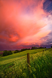 A photograph of one of a stunning display of sunset light illuminating high clouds following a late afternoon intense storm on the plains of Nebraska. - Nebraska Photograph