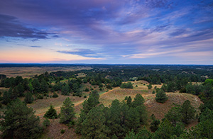 Clouds roll over Halsey National Forest in the central Nebraska.  From the Scott Tower lookout the largest handplanted forest in the United States extends into the distance. - Nebraska Photograph