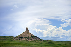 Afternoon storm clouds gather in the west billowing above Chimney Rock in the panhandle of Nebraska. - Nebraska Photograph