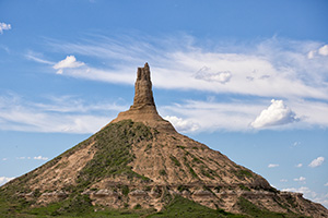 Clouds float above Chimney Rock, once a beacon to pioneers headed to the west for a better life. - Nebraska Photograph