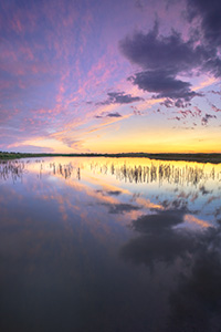 A scenic landscape photograph of a sunset reflected in the water at Jack Sinn WMA in eastern Nebraska. - Nebraska Photograph