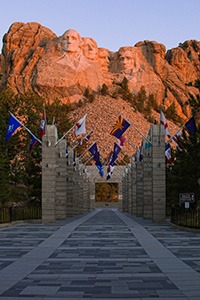 Mt. Rushmore National Monument at sunrise with the Avenue of Flags in the Black Hills of South Dakota. - South Dakota Photograph