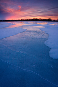 The former oxbow of the Missouri River, the oxbow at DeSoto National Wildlife Refuge is completely frozen on a frigid January evening. - Nebraska Photograph