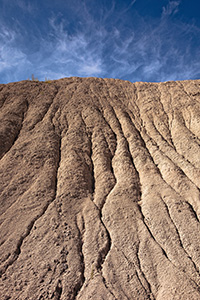 Clouds float lazily over the eroded hills at Toadstool Geologic Park. - Nebraska Photograph