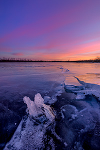 A scenic landscape photograph of the sunset over the frozen lake at DeSoto NWR, Nebraska. - Nebraska Photograph