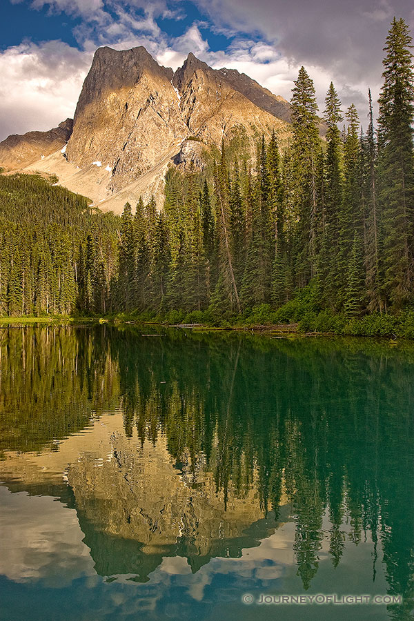 After relaxing dinner at the little restaurant that over looks this lake, I captured this photograph.  I enjoyed how the the dappled, warm afternoon sun washed over the mountain.  Emerald Lake in Yoho National Park, British Columbia, Canada. - Canada Photography