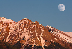The moon rises over the peaks on the Kootenay Plains in Western Alberta. - Canada Photograph