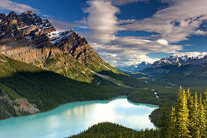 Peyto Lake in Banff National Park is known for its turquoise blue water caused by runoff from the nearby Glacier.  Most photographers will tell you to photograph this scene in the afternoon in order to maximize the reflection of the mountains on the lake.  I, however, wanted to see how it would look in the early morning.  After photographing the sunrise on Bow Lake I traveled the short distance to Peyto Lake to capture this image. - Canada Photograph
