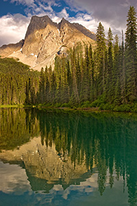 After relaxing dinner at the little restaurant that over looks this lake, I captured this photograph.  I enjoyed how the the dappled, warm afternoon sun washed over the mountain.  Emerald Lake in Yoho National Park, British Columbia, Canada. - Canada Photograph